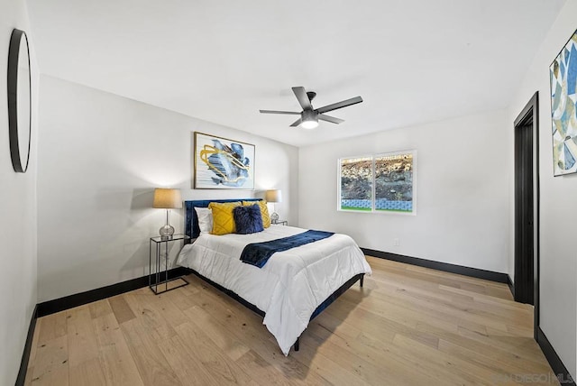 bedroom with ceiling fan and light hardwood / wood-style floors