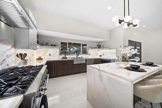 kitchen with sink, extractor fan, dark brown cabinets, stainless steel appliances, and decorative backsplash