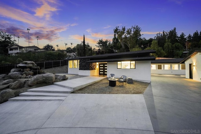 view of front facade featuring a patio area and an outdoor fire pit