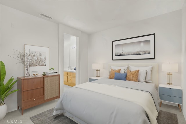 bedroom featuring light colored carpet and connected bathroom