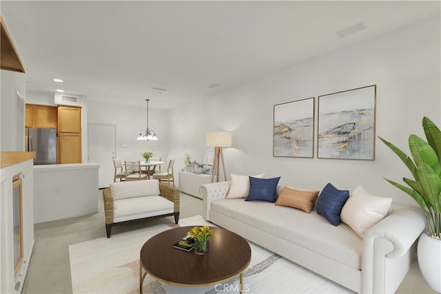 living room featuring light carpet and an inviting chandelier