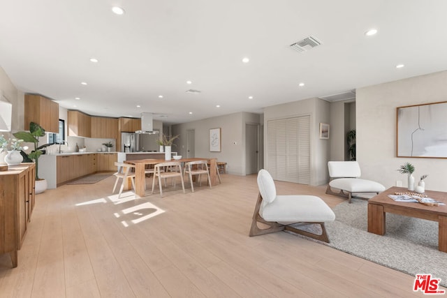 living room featuring light wood-type flooring and sink