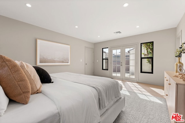 carpeted bedroom with access to exterior and french doors