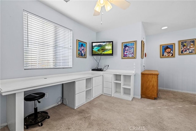 office area featuring light carpet and ceiling fan