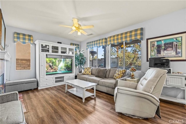 living room featuring ceiling fan and dark wood-type flooring