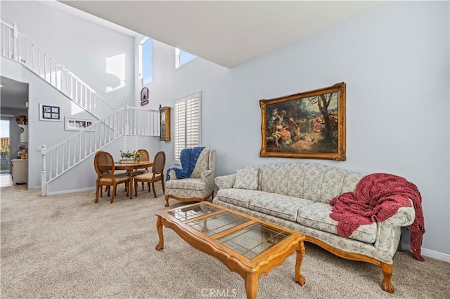 carpeted living room featuring a high ceiling