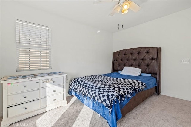 bedroom featuring light carpet and ceiling fan