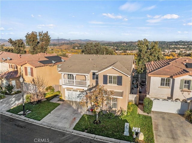 view of front of property with a balcony and a garage