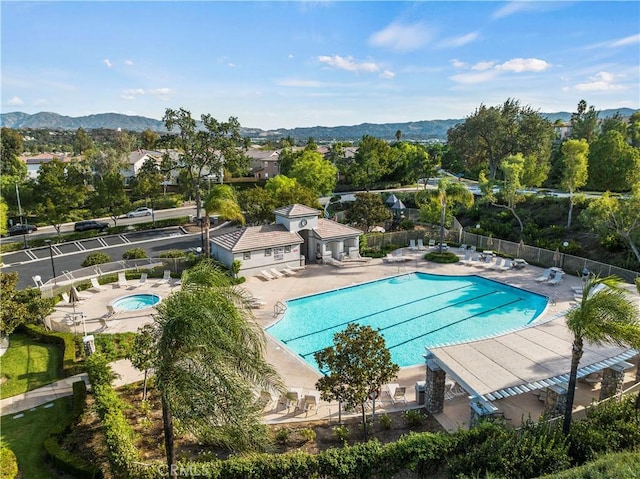 view of swimming pool with a mountain view and a patio area