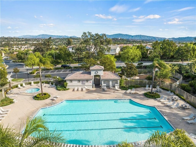 view of swimming pool featuring a mountain view and a patio