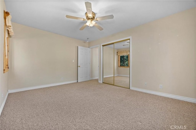 unfurnished bedroom featuring carpet floors, a closet, and ceiling fan