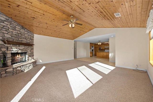 unfurnished living room with light carpet, vaulted ceiling, ceiling fan, wooden ceiling, and a stone fireplace