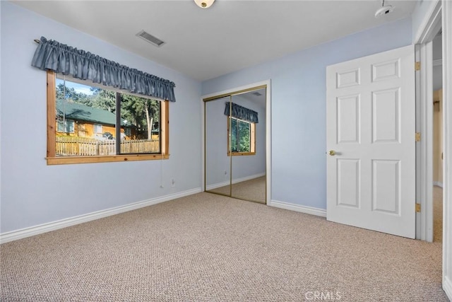 unfurnished bedroom with carpet and a closet