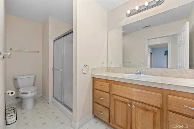 bathroom featuring toilet, vanity, and walk in shower