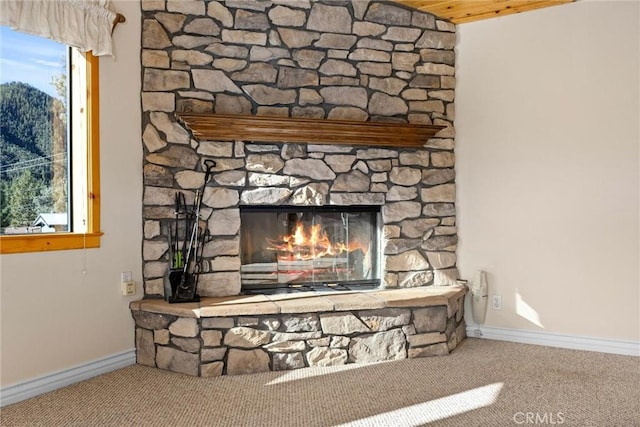 details with carpet flooring and a stone fireplace