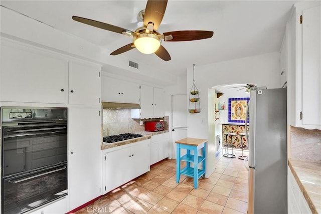 kitchen with decorative backsplash, white cabinets, and black appliances