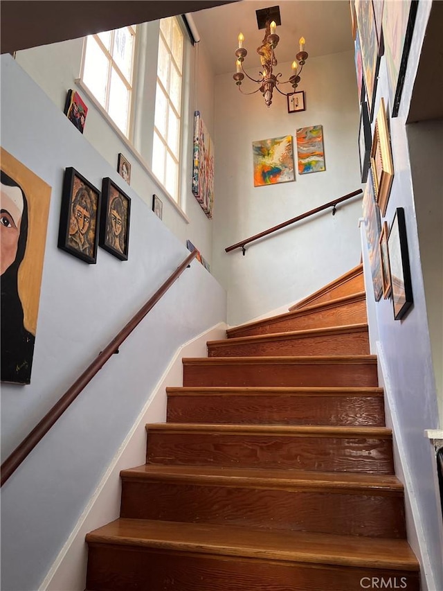 stairway with a chandelier