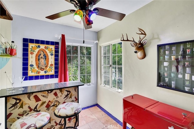 sitting room featuring ceiling fan and light tile patterned floors