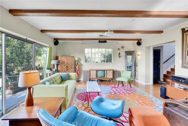 living room featuring hardwood / wood-style floors, plenty of natural light, and beamed ceiling