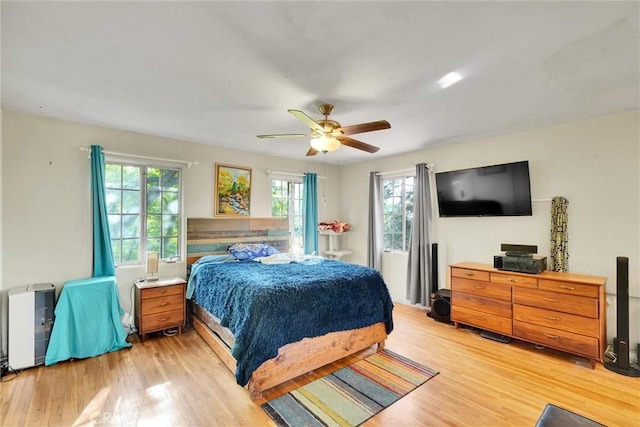 bedroom with light wood-type flooring and ceiling fan