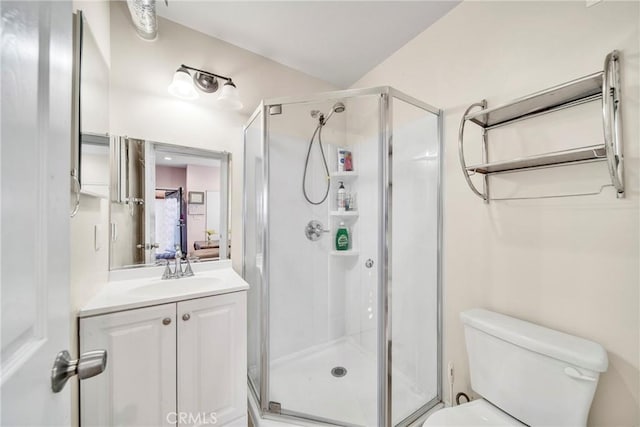 bathroom with vanity, toilet, and walk in shower