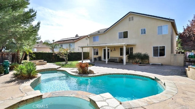 view of swimming pool featuring a patio area and an in ground hot tub