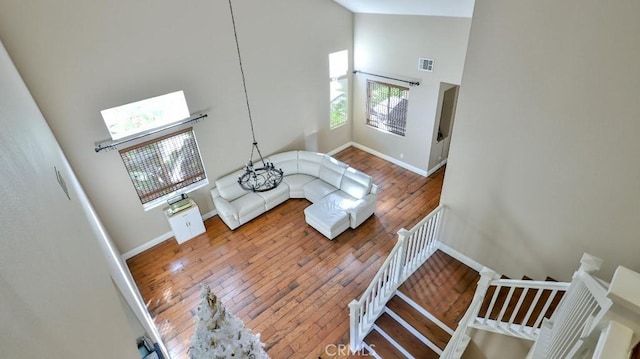 living room featuring hardwood / wood-style floors and high vaulted ceiling