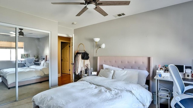 carpeted bedroom featuring ceiling fan and a closet