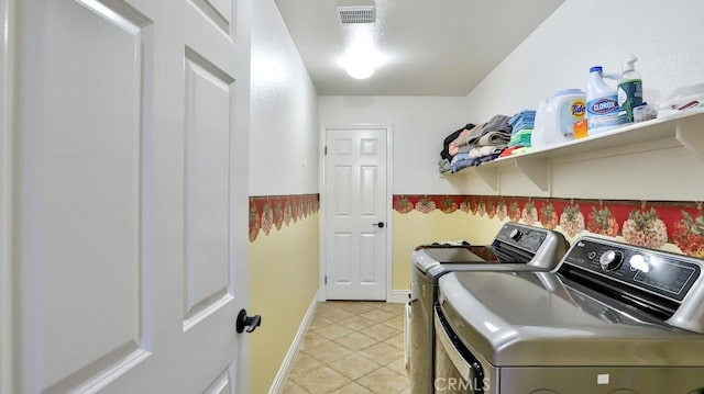 laundry area featuring separate washer and dryer and light tile patterned flooring