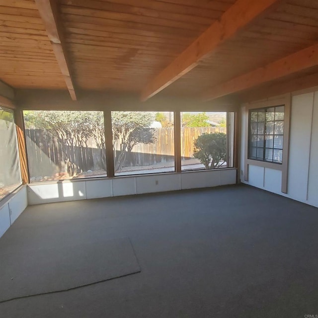 unfurnished sunroom with beamed ceiling and wood ceiling