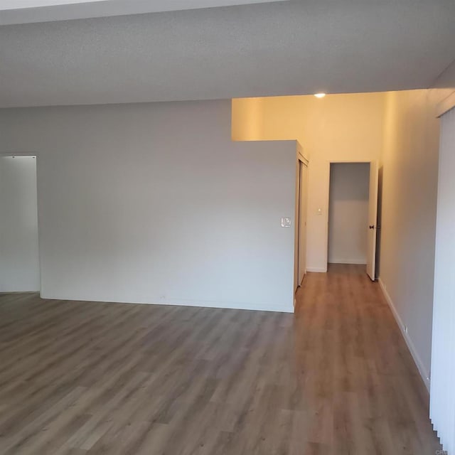 empty room with hardwood / wood-style flooring