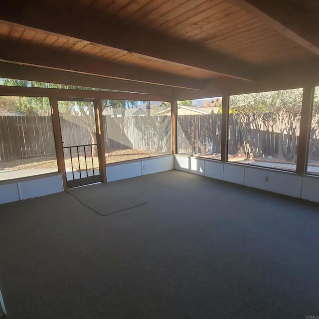 unfurnished sunroom featuring plenty of natural light, wood ceiling, and beam ceiling