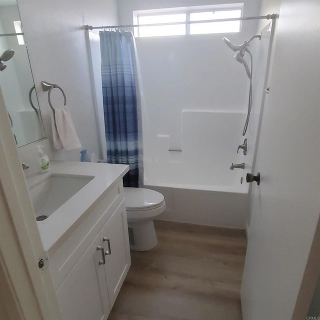 full bathroom featuring vanity, toilet, hardwood / wood-style floors, and shower / bath combo with shower curtain