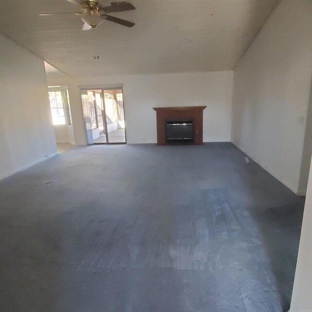 unfurnished living room featuring ceiling fan