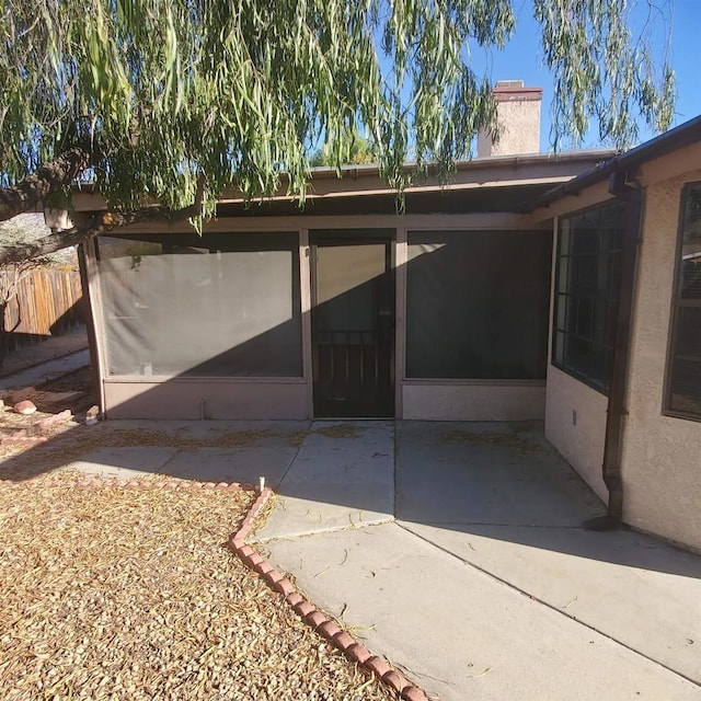 entrance to property featuring a patio