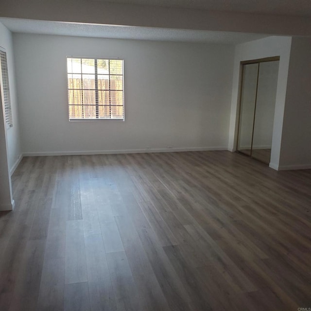 unfurnished room featuring dark hardwood / wood-style flooring