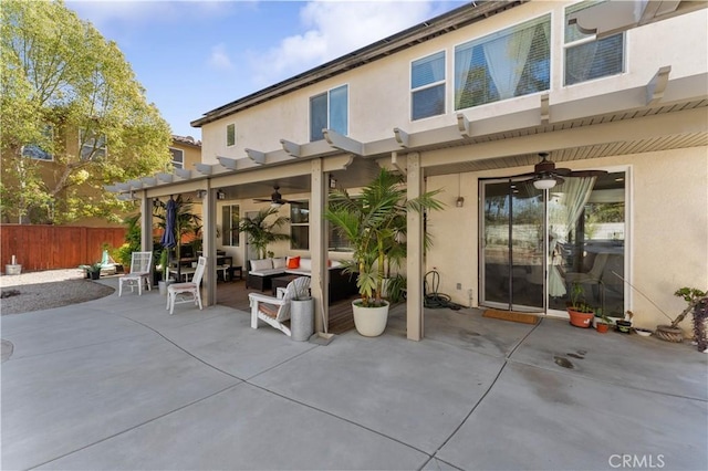 back of house featuring outdoor lounge area, ceiling fan, and a patio area