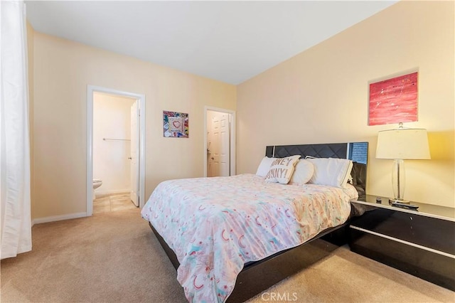 bedroom featuring ensuite bathroom, a closet, and light colored carpet