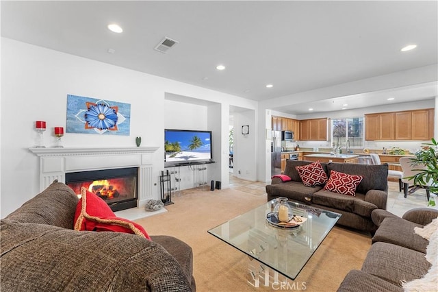 carpeted living room featuring sink