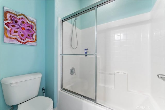 bathroom featuring shower / bath combination with glass door and toilet