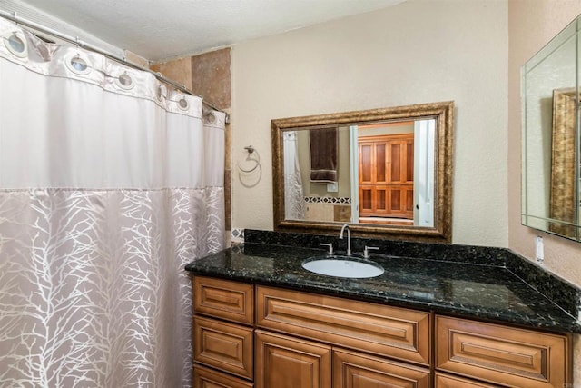 bathroom featuring vanity and a textured ceiling