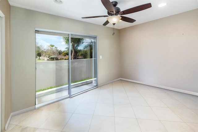 unfurnished room with ceiling fan and light tile patterned flooring