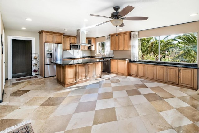 kitchen featuring ceiling fan, a kitchen island, island exhaust hood, and stainless steel appliances