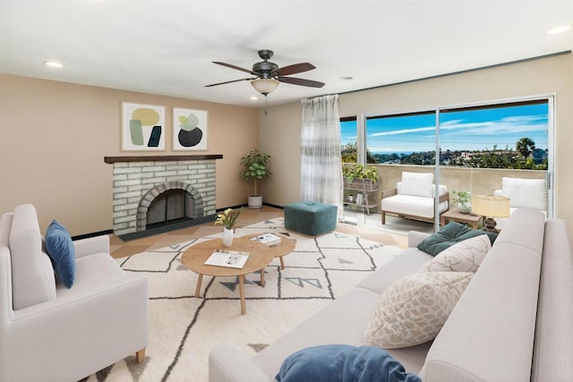 living room featuring a brick fireplace and ceiling fan