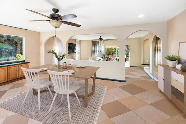 dining area with ceiling fan and light tile patterned floors