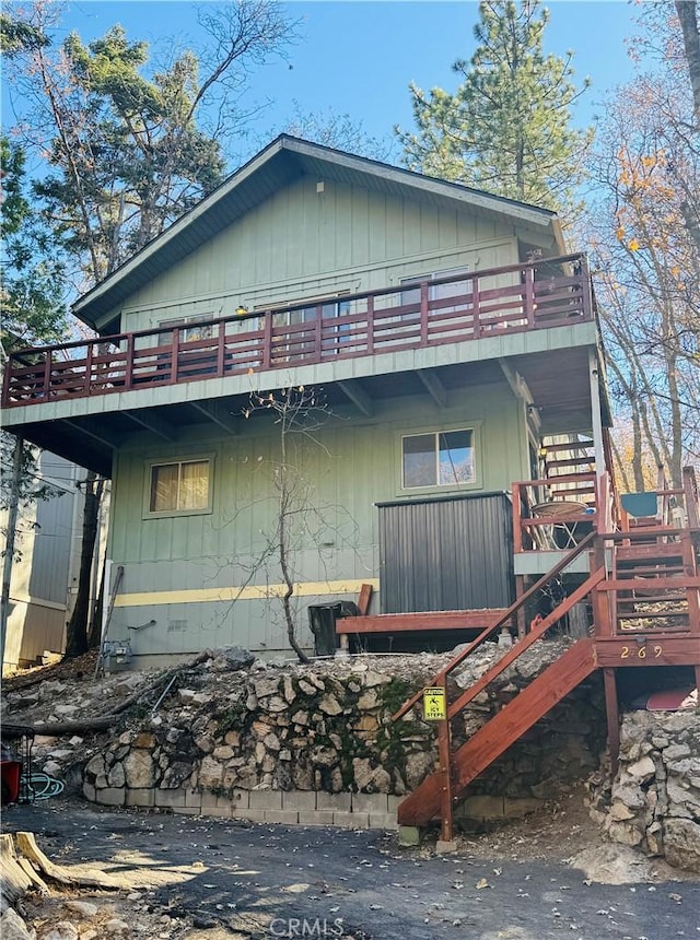 view of side of home featuring a wooden deck