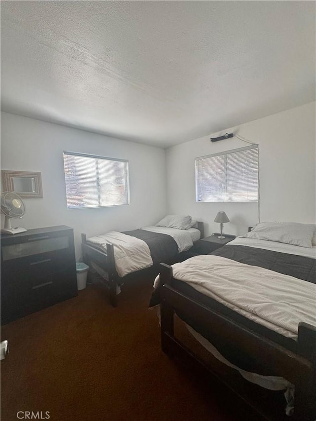 carpeted bedroom with a textured ceiling