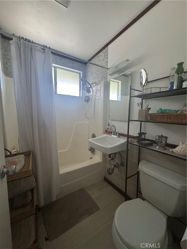 full bathroom with sink, shower / bath combo, and toilet