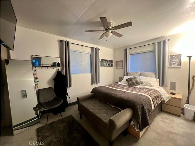 bedroom featuring ceiling fan and light colored carpet