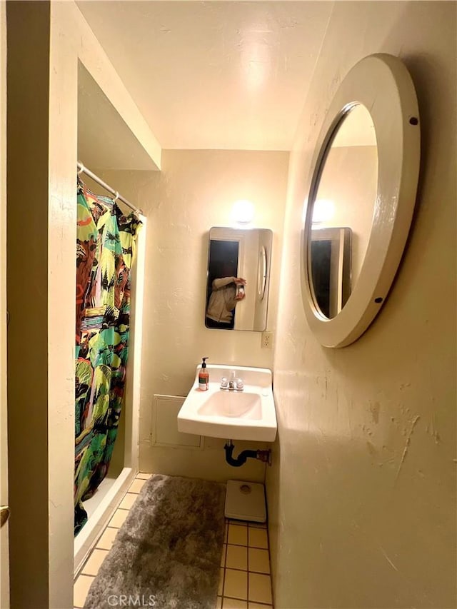 bathroom featuring sink, tile patterned floors, and a shower with shower curtain